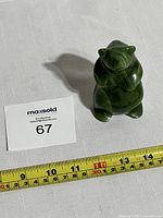 Front view of green nephrite jade bear figurine showing polished surface and rounded carving