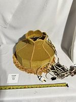 Top view of gold velvet hanging lamp shade with swag chain and electrical plug, showing shape and condition.
