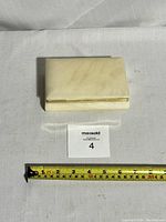 Closed alabaster trinket box with measuring tape showing approximately 6 inches width.