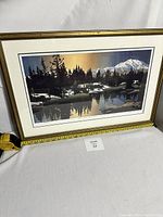 Framed Byron Birdsall print with ruler showing approximate 26 x 18 inch dimensions, depicting a snowy mountain scene reflected in a lake.