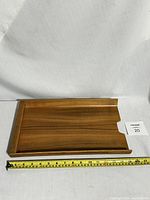 Top-down photo of the rectangular vintage Swedish teak tray showing wood grain and raised edges.