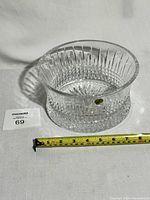 Side view of the Waterford crystal bowl showing the shape, diamond cut pattern, and including a tape measure for dimension reference.
