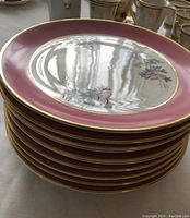 Side view stack of 12 pink floral luncheon plates showing the pink and gold trim edges with floral pattern on front.