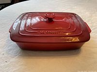 Assembled rectangular casserole dish with lid in red enamel-coated cast iron