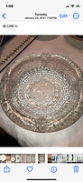 Top-down view of clear glass ashtray or trinket dish showing concentric circle textured pattern and ridged edges