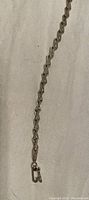 Full length view of the sterling silver ornate link bracelet showing the design and clasp.
