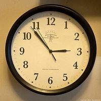 Stratosphere radio-controlled wall clock with black frame and white dial showing time around 2:53:55.