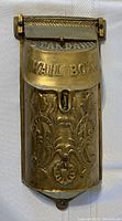 Front view of the heavy brass mailbox showing decorative embossing and the 'Standard Mail Box' inscription.