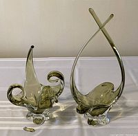 Overview of the two olive green glass chalets, highlighting size difference and shapes.