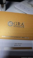 GRA Moissanite certification box with logo visible.
