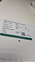 Photo of natural yellow sapphire and its gemstone identification report showing details like date, shape, size, weight, color, clarity, and enhancements.