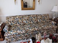 Front full view of floral upholstered Ethan Allen sofa showing its length and floral cushion pattern.