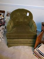 Front view of green upholstered Ethan Allen side chair with button tuft backrest and skirted base.