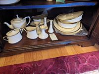Overall shot of Lenox Eternal pieces including teapot, creamer, sugar bowl, candle holders, salt & pepper shakers, gravy boat, vegetable dishes and serving platter