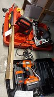 Black & Decker drill, Craftsman biscuit joiner, and Homelite chainsaw all shown together with cases and some packaging.