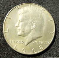 Front side of 1968 Kennedy half dollar coin showing JFK portrait and date.