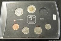 Front view of 2004 Canadian specimen coin set with six coins present and one empty slot for loonie.