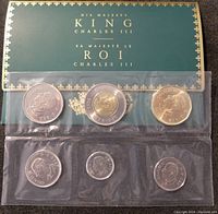 Front side of the 6 coin set showing obverse with King Charles III portraits and original green packaging