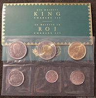 Front and back views of six uncirculated Canadian coins from 2023 featuring King Charles III, displayed in a clear protective sleeve with green backing card labeled with His Majesty King Charles III in English and French.