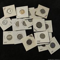 Overview of the lot showing 16 Canadian 5 cents coins in protective cardboard holders with visible dates ranging from 1922 to 1996.