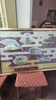 Framed artwork showing multiple Asian architectural landmarks with stylized clouds and ornate design.