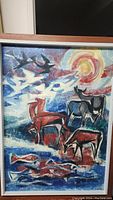 Framed painting showing landscape with stylized animals and birds beneath a sun, signed by artist.