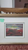 Framed oil painting on wood panel, showing abstract landscape with red, green, purple, yellow, and blue brushstrokes.