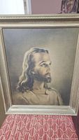 Full view of framed vintage religious print showing portrait of Jesus Christ in soft sepia tone with metallic frame.