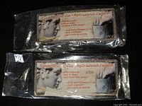 Two sealed 500g packs of natural modeling clay side by side showing label with sculpture imagery and multilingual text