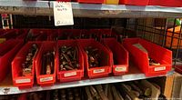 Photo of shelf with red plastic bins holding various sizes of hex cap screws and nuts