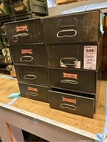 Eight metal storage drawers labeled with plumber hardware terms, including nuts and bushings