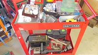 Photo of red Craftsman tool cart top shelf showing pneumatic tools and inflator