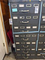 Front view showing all seven drawers with label holders and metal handles
