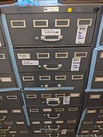 Front view of the seven drawer steel file cabinet with labels for screwdriver types and tools.