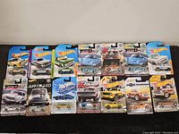 Full lot of 14 Hot Wheels cars on original blister cards, showing a variety of series and models.