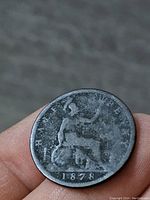 Reverse side of the 1878 British Half Penny coin showing seated Britannia holding trident and shield with date 1878 below.