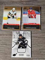 Front of 3 Upper Deck NHL jersey cards showing Peyton Krebs, Connor McMichael, and Samuel Fagemo with embedded jersey pieces.