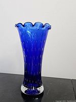 Full view of cobalt blue glass vase showing controlled bubbles and ruffled top.