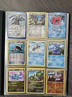 Nine Pokemon trading cards visible, including Uranring, Honedge, Octillery, Roller Skates Trainer, Lapras, Cryogonal, Bagon, Vibrava, and Gurdurr in plastic sleeves.
