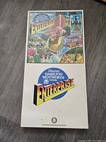 Top view of the closed game box with colorful lid artwork featuring buildings, wildlife, and scenic landmarks representing Hamilton-Wentworth Canada.