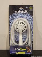 Front view of the brand new Waterpik EcoFlow handheld shower head and hose in original packaging showing model ETC-441 and Waterpik branding.
