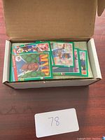 Box filled with assorted baseball cards including an MVP card and various player images