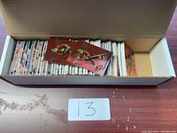 Open box filled with a variety of hockey cards mostly arranged vertically, some cards visible on top with player images on red backgrounds