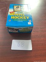 Closed box of 1991 Score Series 2 NHL hockey cards on wooden surface showing original packaging and graphics.