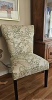 Single chair showing upholstery pattern, nailhead trim, and leg finish