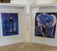 Both framed pictures side by side on a tabletop: left is stylized woman with blue theme, right is blue iris flower close-up.