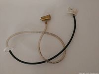 Photo of oxygen stone with connected hoses and brass adapter, showing the components and their condition.