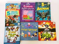 Photo showing all six large story books arranged in two rows: Nickelodeon 5-Minute Adventure Stories Collection, 5-Minute Peppa Pig Stories, 5-Minute Batman Stories, LEGO Super Heroes 5-Minute Super Hero Stories, Peppa Pig Story Treasury, and Marvel Avengers Storybook Collection.