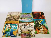 Nine children's books displayed flat, colorful illustrations visible, various educational themes