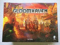 Top view of the Gloomhaven game box showing fantasy city artwork and title.